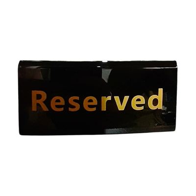 Black "Reserved" table sign