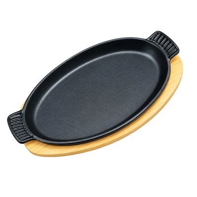 Oval cast iron sizzler with wooden base